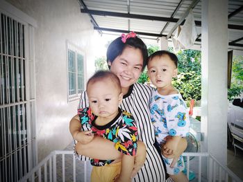 Portrait of mother with kids at home