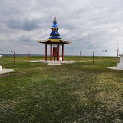 Lifeguard hut on field against sky