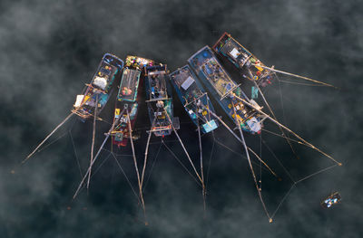 Directly above shot of fishing boats in sea during foggy weather