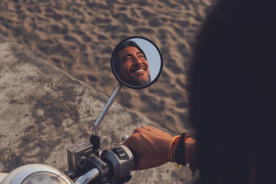 Happy man riding bike on beach