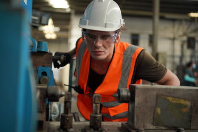 Portrait of male worker standing in the heavy industry manufacturing factory.
