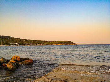 Scenic view of sea against clear sky during sunset