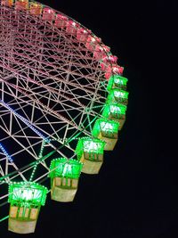 Low angle view of illuminated ferris wheel