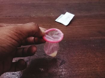 High angle view of hand holding drink on table