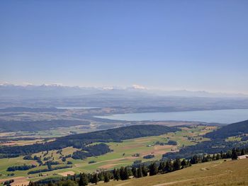 Scenic view of agricultural landscape against clear sky