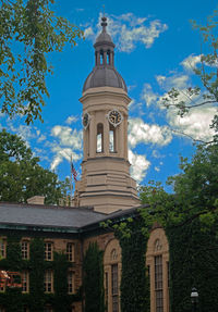 Low angle view of building and trees against sky