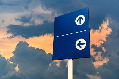 Low angle view of road sign against sky