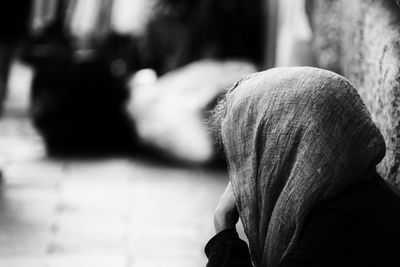 Close-up of senior man sitting on road