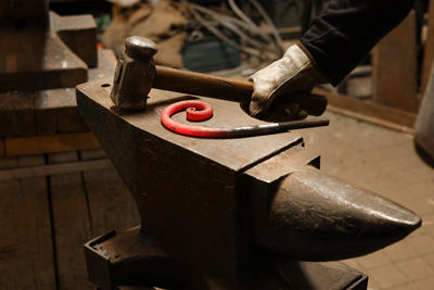 Close up view of heated metal and anvil. the blacksmith in the production process of metal products