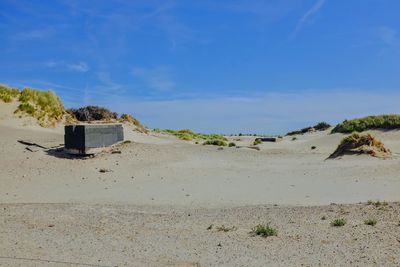 Scenic view of beach against blue sky