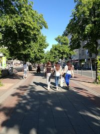 People in town square against sky