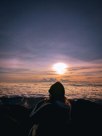 Woman against sea during sunset