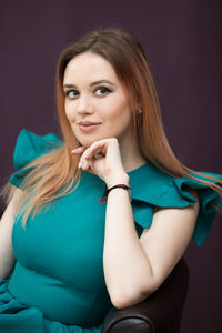 Portrait of a beautiful young woman over black background