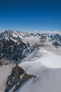 Snowy peaks and mountains in a sunny day, viewed from the aiguille du midi, near chamonix, france.