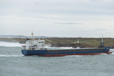 Ship sailing on sea against sky