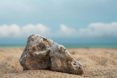 Rocks on beach against sky