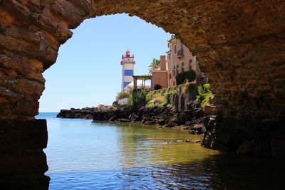 View of historic building seen through cave