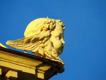 Low angle view of statue against clear blue sky