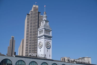 Low angle view of buildings against blue sky