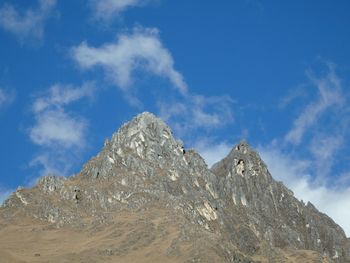 Scenic view of mountains against cloudy sky