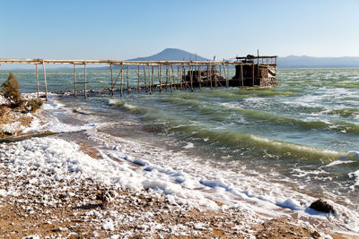 Pier over sea against clear sky