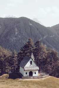 House on mountain against sky