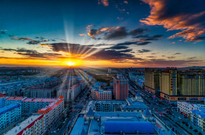 High angle view of buildings against sky during sunset