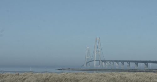 Bridge over field against sky