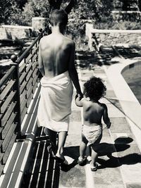 Rear view of sibling walking together outdoors