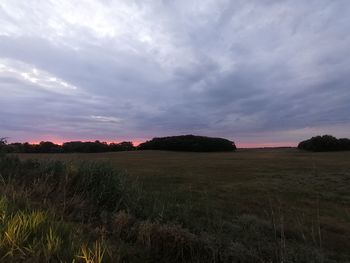 Scenic view of field against sky during sunset