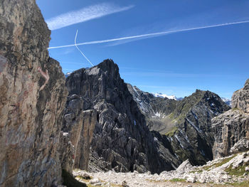 Scenic view of mountains against blue sky