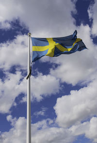 Low angle view of flags flag against sky