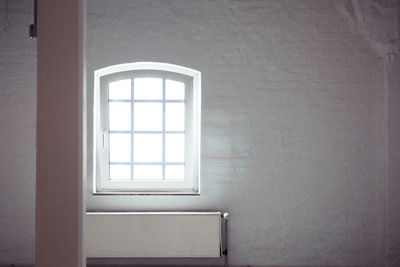 Window amidst white wall
