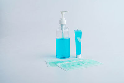 Close-up of blue bottle against white background