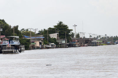 Town in harbor against clear sky