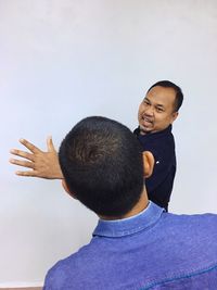 Portrait of boy standing against white background