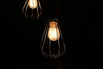 Low angle view of illuminated light bulbs