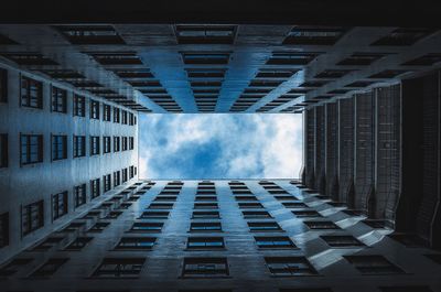 Directly below shot of buildings against sky