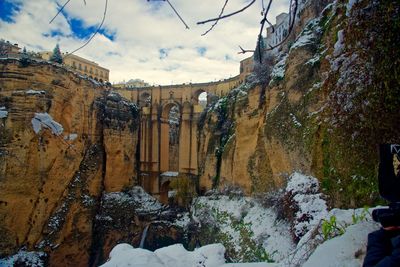 Close-up of snow on tree against sky