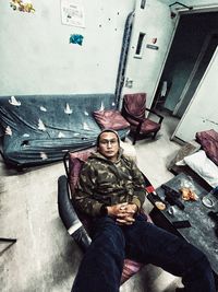 High angle view of man sitting on floor