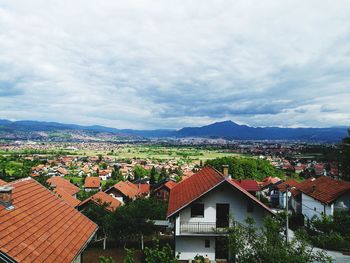High angle view of houses in town against sky