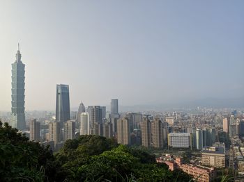 Modern buildings in city against clear sky