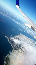 Cropped image of airplane flying over sea