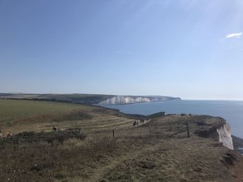 Scenic view of field against clear blue sky