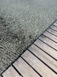 High angle view of boardwalk by swimming pool