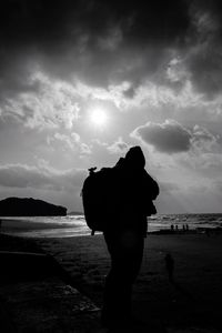 Silhouette of man standing at beach