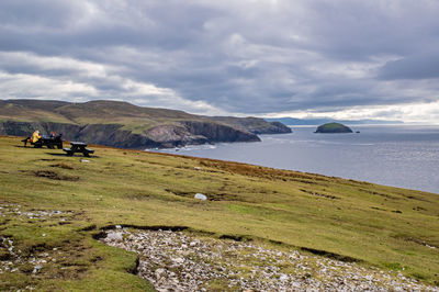 Scenic view of sea and mountains against sky