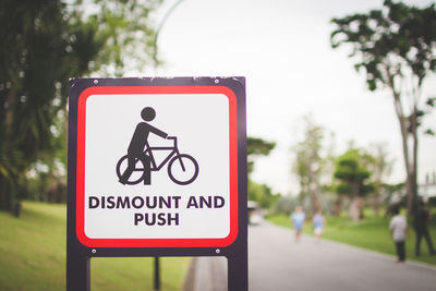 Road sign against trees