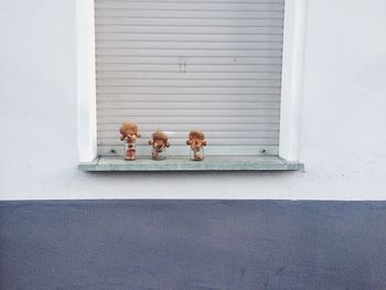 Brown toys in jars on window sill