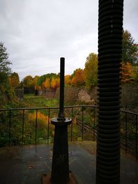 Gazebo by trees against sky